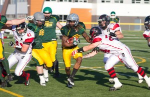 Fort McMurray Monarchs running back Melvin Abankwah, middle, attempts to fight his way past defenders from the Central Alberta Buccaneers Saturday night at Fuhr Field in Spruce Grove. Robert Murray/Fort McMurray Today/Postmedia Network