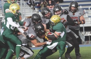 Airdrie Irish running back Matt Huntley (right) battled a wall of Calgary Gators defensive players during the Irish's 44-0 loss at Ed Eggerer Athletic Park July 9. Andrew Halipchuk/Rocky View Publishing