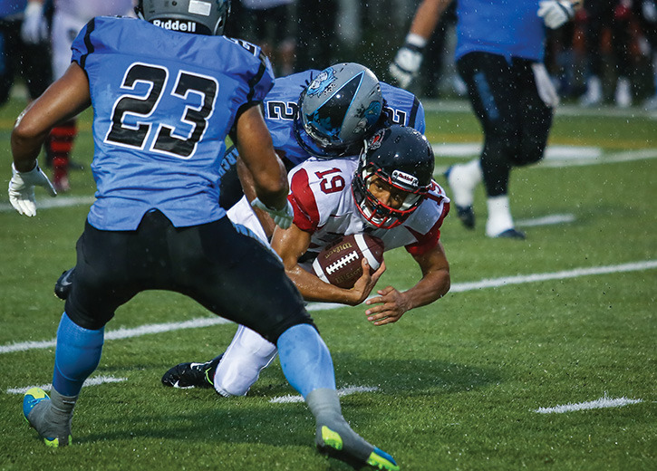 GOOD EFFORT- Counter-clockwise from right Axsavier Lawrence of the Central Alberta Buccaneers was tackled by Jourdain Alexis and Aaron Gordon of the Fort McMurray Monarchs during the Alberta Football League Final at MEGlobal Athletic Park in this Express file photo from the AFL Final this past summer. Zachary Cormier/Lacombe Express